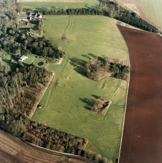 Oblique aerial view centred on the deserted medieval village, bastle, church and burial ground, with remains of the rig, possible enclosures, country house and walled garden adjacent, taken from the WSW.