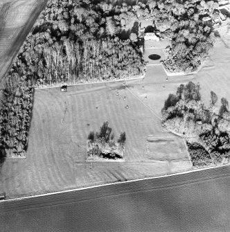 Oblique aerial view of the remains of the deserted medieval village and bastle, church and burial ground, with remains of the rig, possible enclosures and country house adjacent, taken from the S.