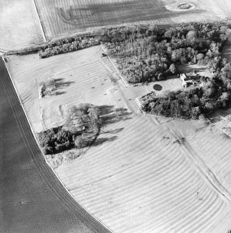 Oblique aerial view of the remains of the deserted medieval village and bastle, church and burial ground, with remains of the rig, possible enclosures and country house adjacent, taken from the ESE.