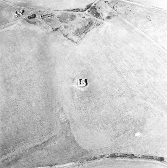 Oblique aerial view centred on the remains of the tower-house with the remains of the farmstead adjacent, taken from the S.