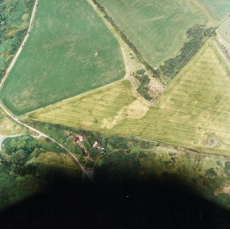 Oblique aerial view centred on the cropmarks of possible ring ditch and pit, taken from the WSW.