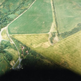 Oblique aerial view centred on the cropmarks of possible ring ditch and pit, taken from the SW.