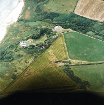 Oblique aerial view centred on the cropmarks of the possible ring ditch and pit with the house adjacent, taken from the SE.