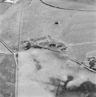 Oblique aerial view centred on the remains of the farmstead with the remains of the tower-house adjacent, taken from the NW.