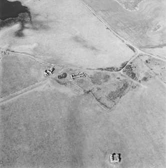 Oblique aerial view centred on the remains of the farmstead with the remains of the tower-house adjacent, taken from the SSE.