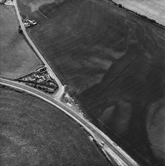 Ballantrae Bridge, oblique aerial view, taken from the NE, showing the cropmarks of field boundaries, two possible souterrains and enclosures, a round house and an area with pits.