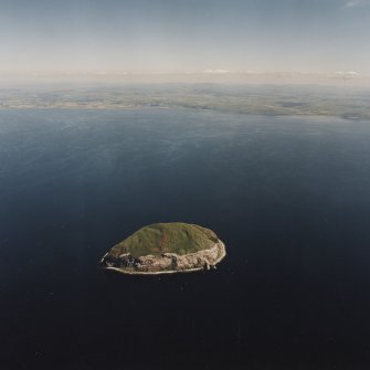 General oblique aerial view looking across Ailsa Craig towards South Ayrshire, taken from the WNW.