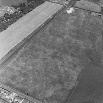 Oblique aerial photograph of Dunragit taken from the WSW, centred on a cropmark complex.