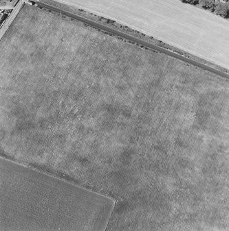 Oblique aerial photograph of Dunragit taken from the SSE, centred on a cropmark complex.