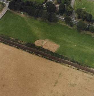 Oblique aerial view centred on the excavation of the pit-defined enclosure, taken from the S.