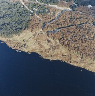 Oblique aerial view centred on the remains of the farmstead and sheepfold, taken from the W.