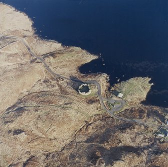 Oblique aerial view centred on the remains of the castle and farmstead, taken from the WNW.