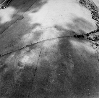 Oblique aerial photograph of Shalloch Hill taken from the ENE, centred on the cropmarks of a palisaded settlement and pits.