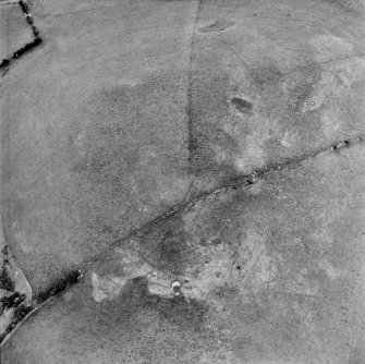 Oblique aerial view centred on the parchmarks of the palisaded settlement with quarries and field boundaries adjacent, taken from the WSW.