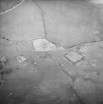 Oblique aerial view centred on the remains of the church, burial ground, homestead moat, building and enclosure with rig adjacent, taken from the WSW.