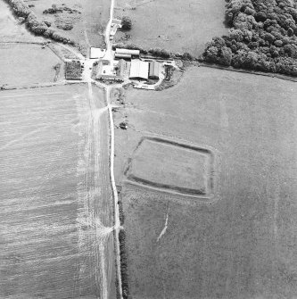 Oblique aerial view centred on the remains of the settlement, taken from the NW.
