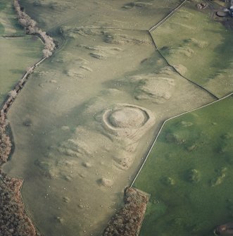 Oblique aerial view centred on the remains of the motte, taken from the WNW.