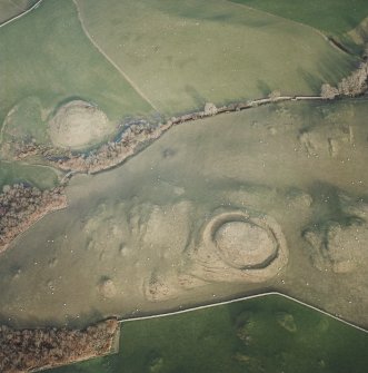 Oblique aerial view centred on the remains of the motte with possible motte adjacent, taken from the WSW.