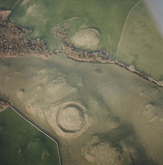 Oblique aerial view centred on the remains of the motte with possible motte adjacent, taken from the SSW.