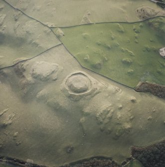 Oblique aerial view centred on the remains of the motte, taken from the NNE.