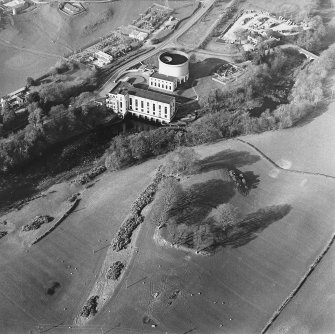 Oblique aerial view centred on the remains of the fort with the power station adjacent, taken from the S.