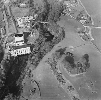 Oblique aerial view centred on the remains of the fort with the power station and road bridge adjacent, taken from the WSW.