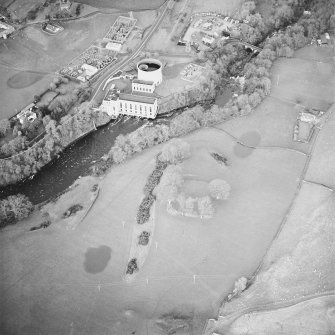 Oblique aerial view centred on the remains of the fort with power station and road bridge adjacent, taken from the SSW.