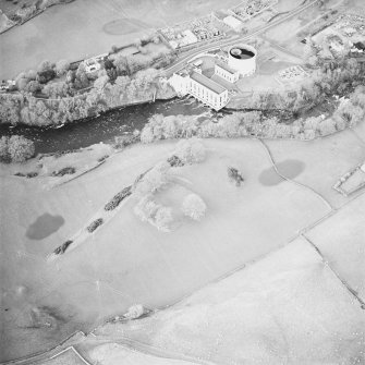Oblique aerial view centred on the remains of the fort with power station adjacent, taken from the SSE.