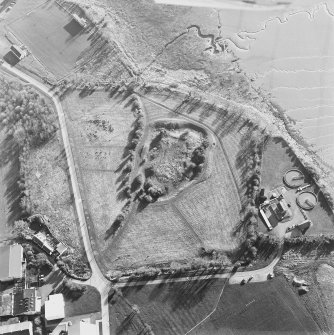 Oblique aerial view centred on the remains of the castle with Castle Mains house adjacent, taken from the NE.