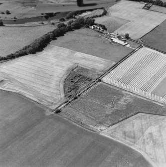 Oblique aerial view of Culvennan, taken from the SE, centered on enclosure and cropmarks.