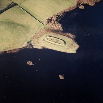 Oblique aerial view centred on the fort with crannogs adjacent, taken from the SSE.