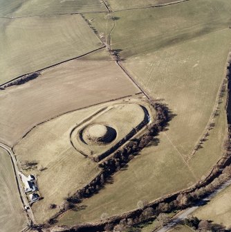 Oblique aerial view centred on the remains of the motte-and-bailey castle, taken from the ESE.