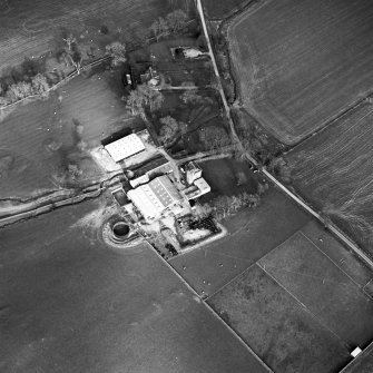 Oblique aerial view centred on the tower house with rig adjacent, taken from the W.