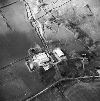 Oblique aerial view centred on the tower house with rig adjacent, taken from the SSE.