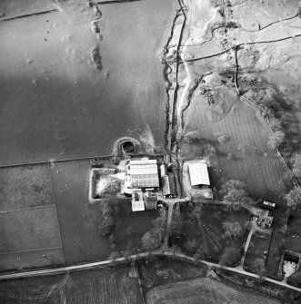 Oblique aerial view centred on the tower house with rig adjacent, taken from the SSE.