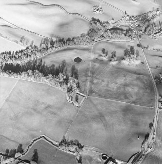 Oblique aerial view centred on the remains of the homestead moat, taken from the SW.