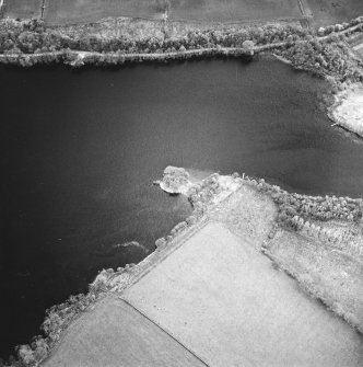 Oblique aerial view centred on the remains of the crannog, taken from the NNE.