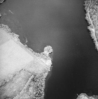 Oblique aerial view centred on the remains of the crannog, taken from the WNW.