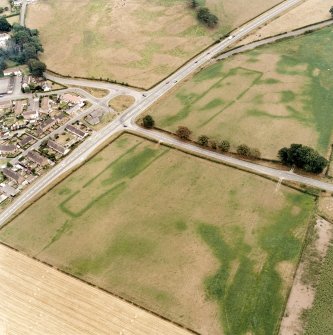 Oblique aerial view of Holywood and Kilncroft, taken from the NW, centred on the southern cursus monument and surrounding cropmarks.