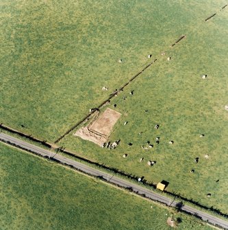Oblique aerial view of The Twelve Apostles centred on the excavation of the stone circle, taken from the SSW.