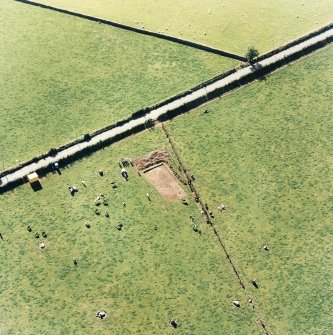 Oblique aerial view of The Twelve Apostles centred on the excavation of the stone circle, taken from the E.