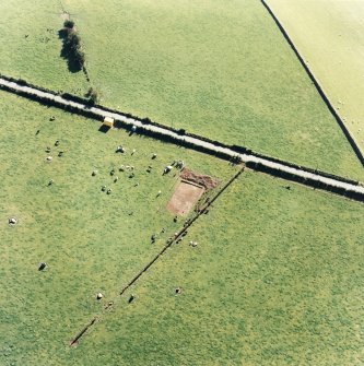 Oblique aerial view of The Twelve Apostles centred on the excavation of the stone circle, taken from the NNE.