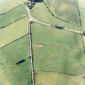 Oblique aerial view of The Twelve Apostles centred on the excavation of the stone circle, taken from the SE.