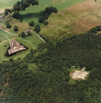 Oblique aerial view centred on the remains of the castle and excavation of the old castle, taken from the S.