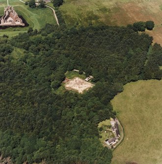 Oblique aerial view centred on the excavation of the old castle with castle adjacent, taken from the SSE.