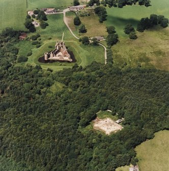 Oblique aerial view centred on the excavation of the old castle with castle adjacent, taken from the SE.