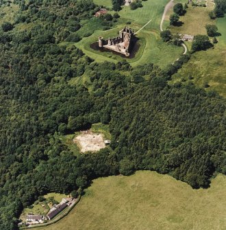 Oblique aerial view centred on the excavation of the old castle with castle adjacent, taken from the SE.