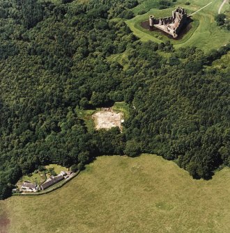 Oblique aerial view centred on the excavation of the old castle with castle adjacent, taken from the ESE.