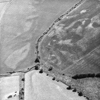 Nethermill School, oblique aerial view, taken from the WNW, showing the cropmark of an enclosure in the centre of the photograph.