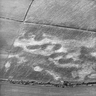Nethermill School, oblique aerial view, taken from the NE, centred on the cropmark of an enclosure.
